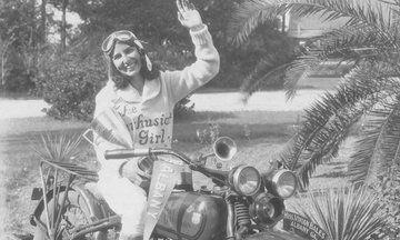 woman waving on a motorcycle