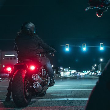 Motorcycle riding down a street