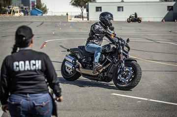 Motorcycle rider with coach on training range