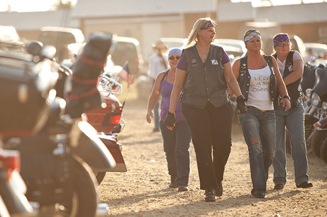 Women walking by motorcycles parked at Pappy Hoel Campground