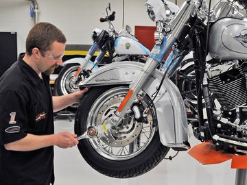 Employee assembling a motorcycle