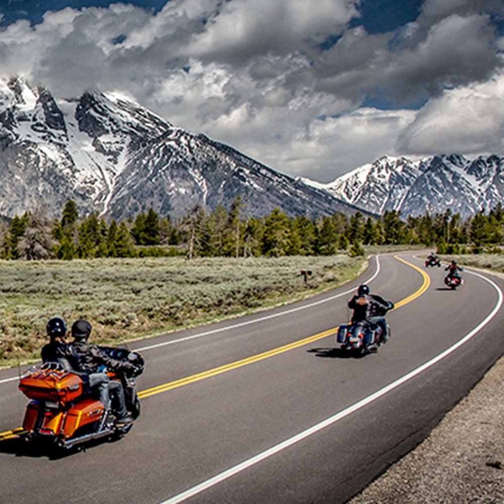 motorcycles riding through mountains