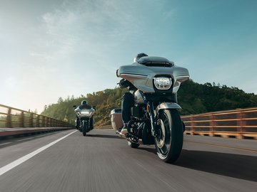 motorcycles crossing a bridge