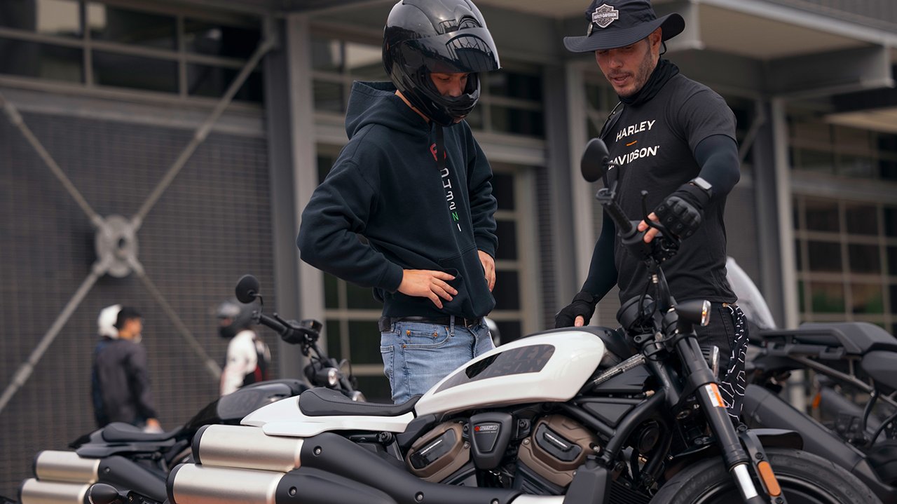 Two men looking at Sportster S motorcycle