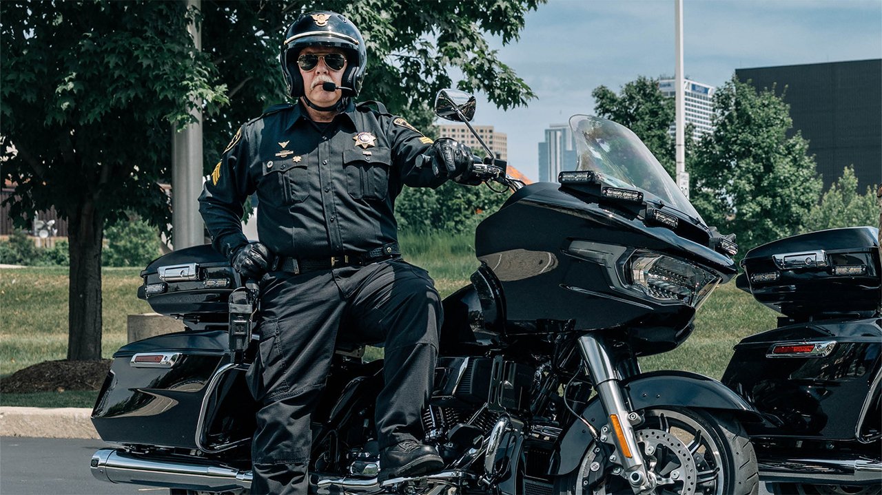 Police officer in uniform sits on a motorcycle