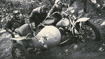 Archive image of riders pushing a bike out of a ditch