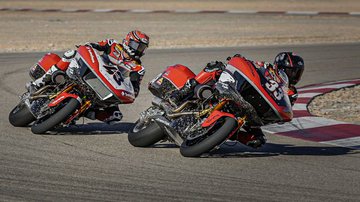 motorcycles going around a curve on track