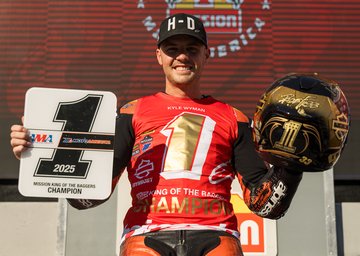 kyle wyman holding number one plate and gold helmet