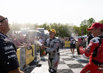 wyman and rispoli celebrate with champagne