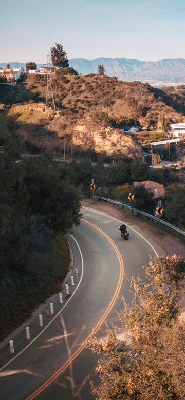 Aerial shot of biker riding on road