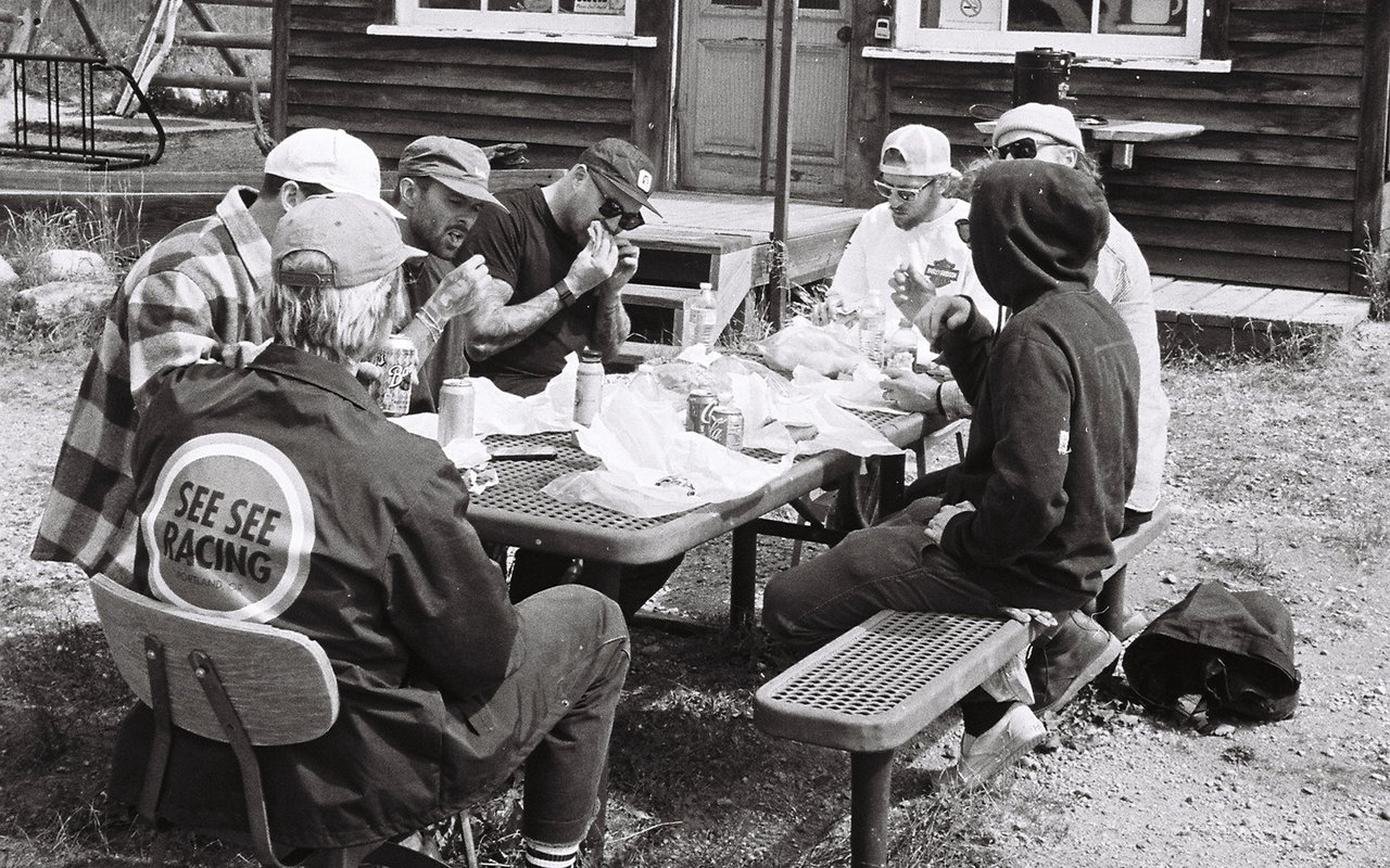 Group of people eating on a picnic table