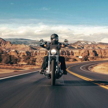 motorcycle driving on desert highway