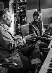 Jorma Vik and Tamara Raye Vik sit at a piano and talk