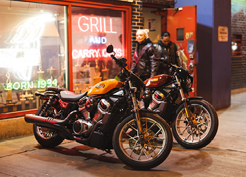 Two Nightster Special motorcycles parked outside of storefront