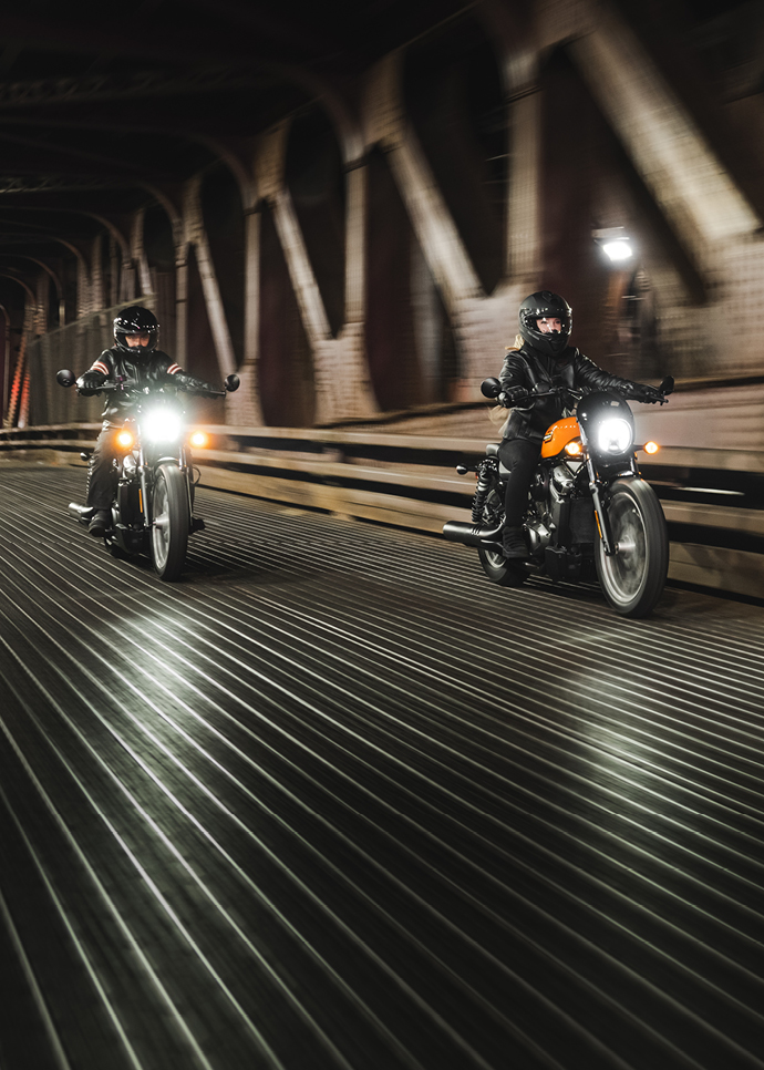 Two motorcyclists cross bridge on their Nightster Special bikes