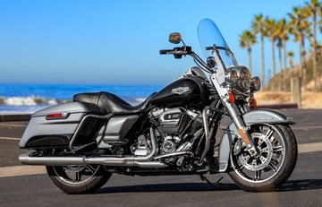 Close up of right front of 2022 Road King in Vivid black, turning a curve