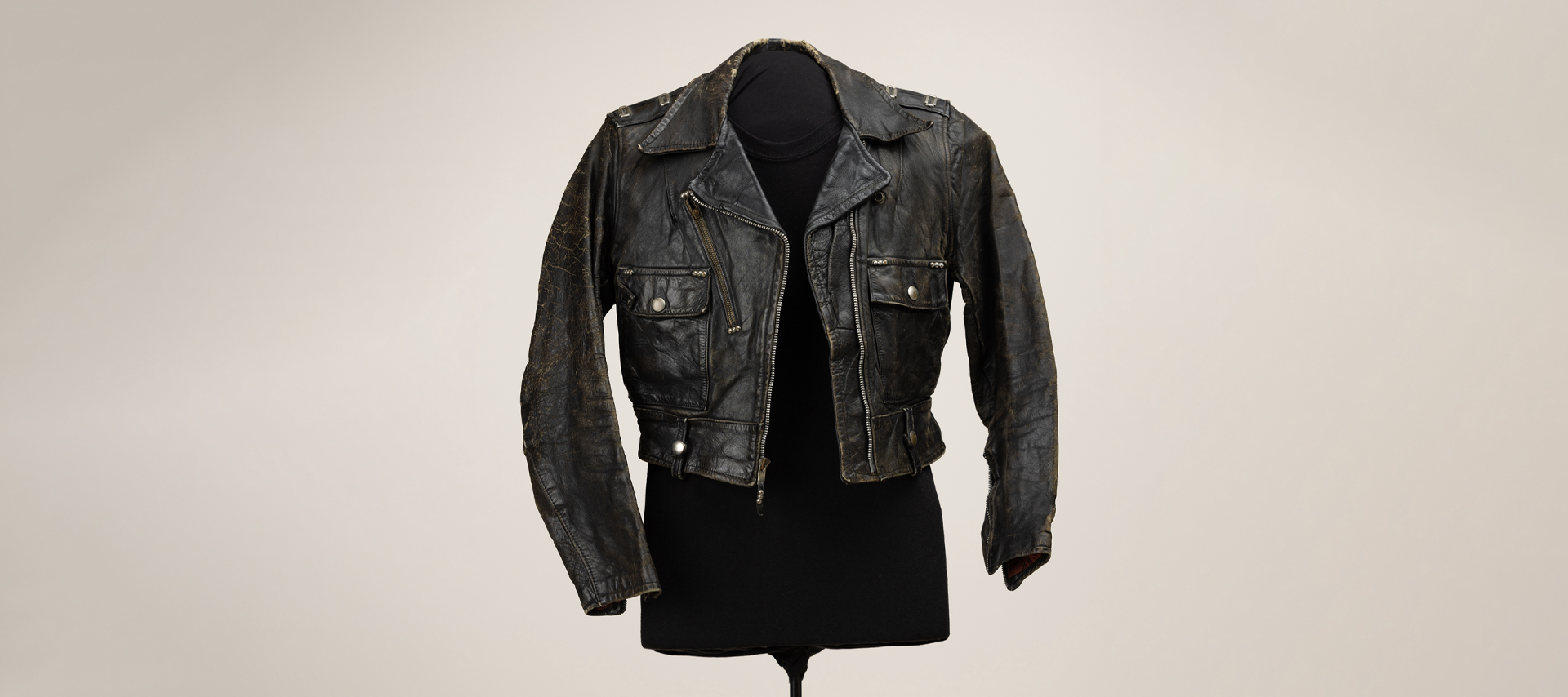 A vintage leather jacket on a mannequin