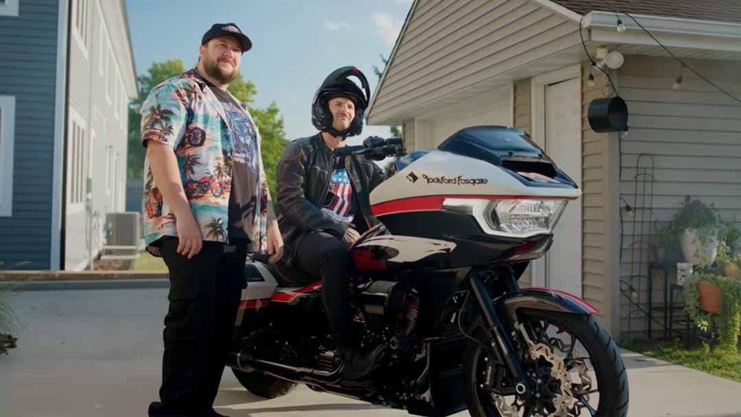 james rispoli on motorcycle with man standing next to him