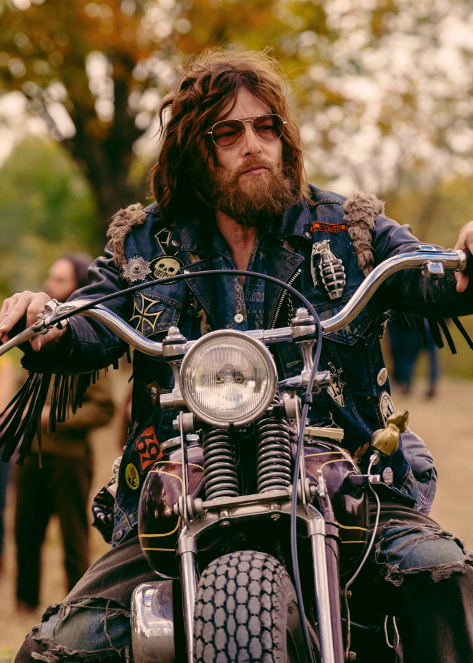 Norman Reedus staring as Funny Sonny sits on his motorcycle