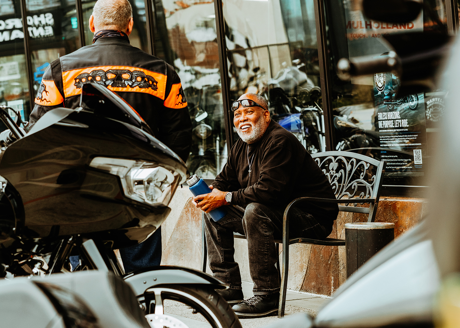 Two customers talk outside of Bartel’s Harley-Davidson dealership.