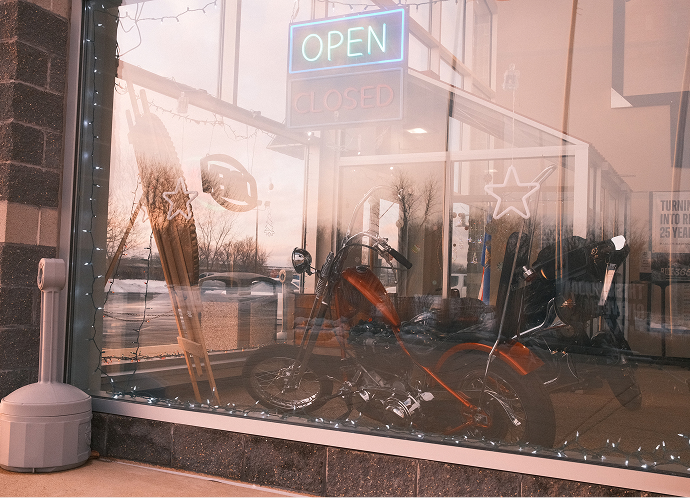 Looking in the front window of Harley-Davidson of Madison at a 1941 Knucklehead chopper on display