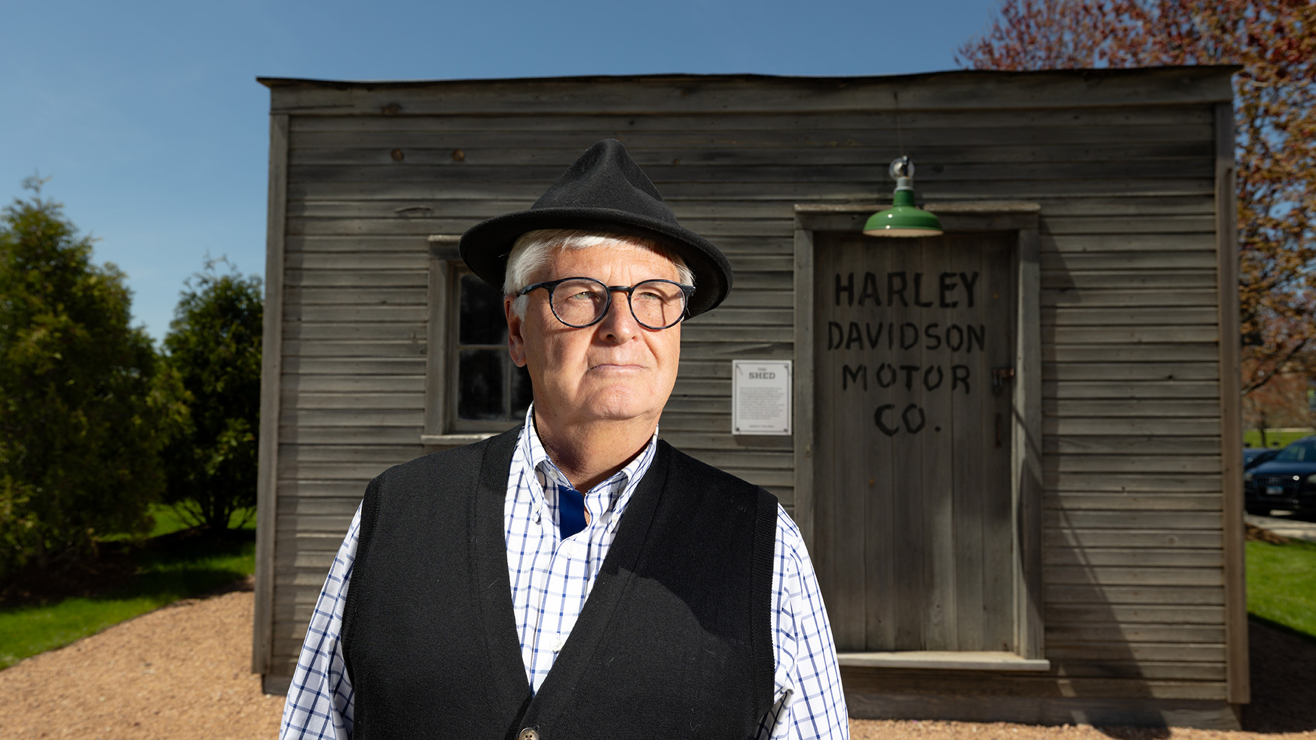 Person standing outside historic Harley-Davidson Motor Co. building