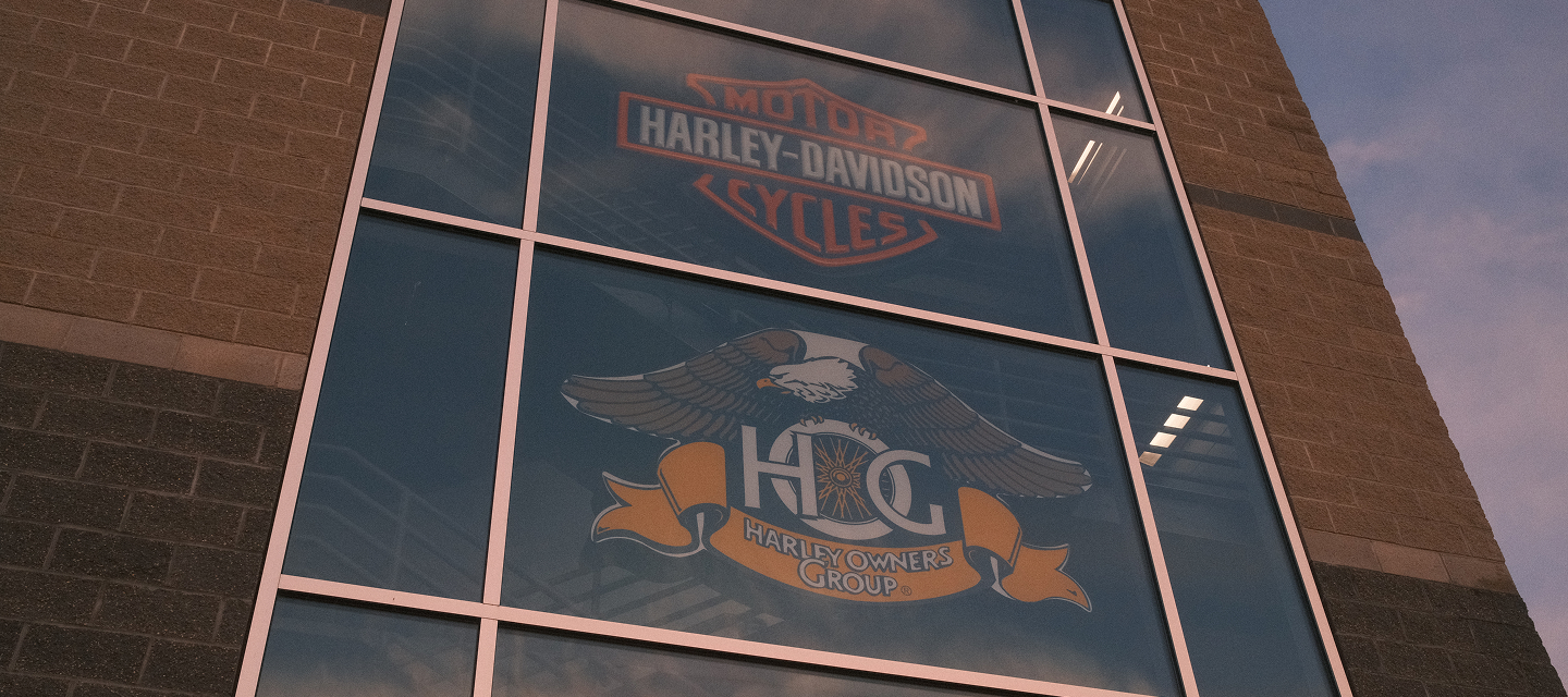  Exterior window view of Harley‑Davidson of Madison building displaying the Harley Owners Group logo and brand signage