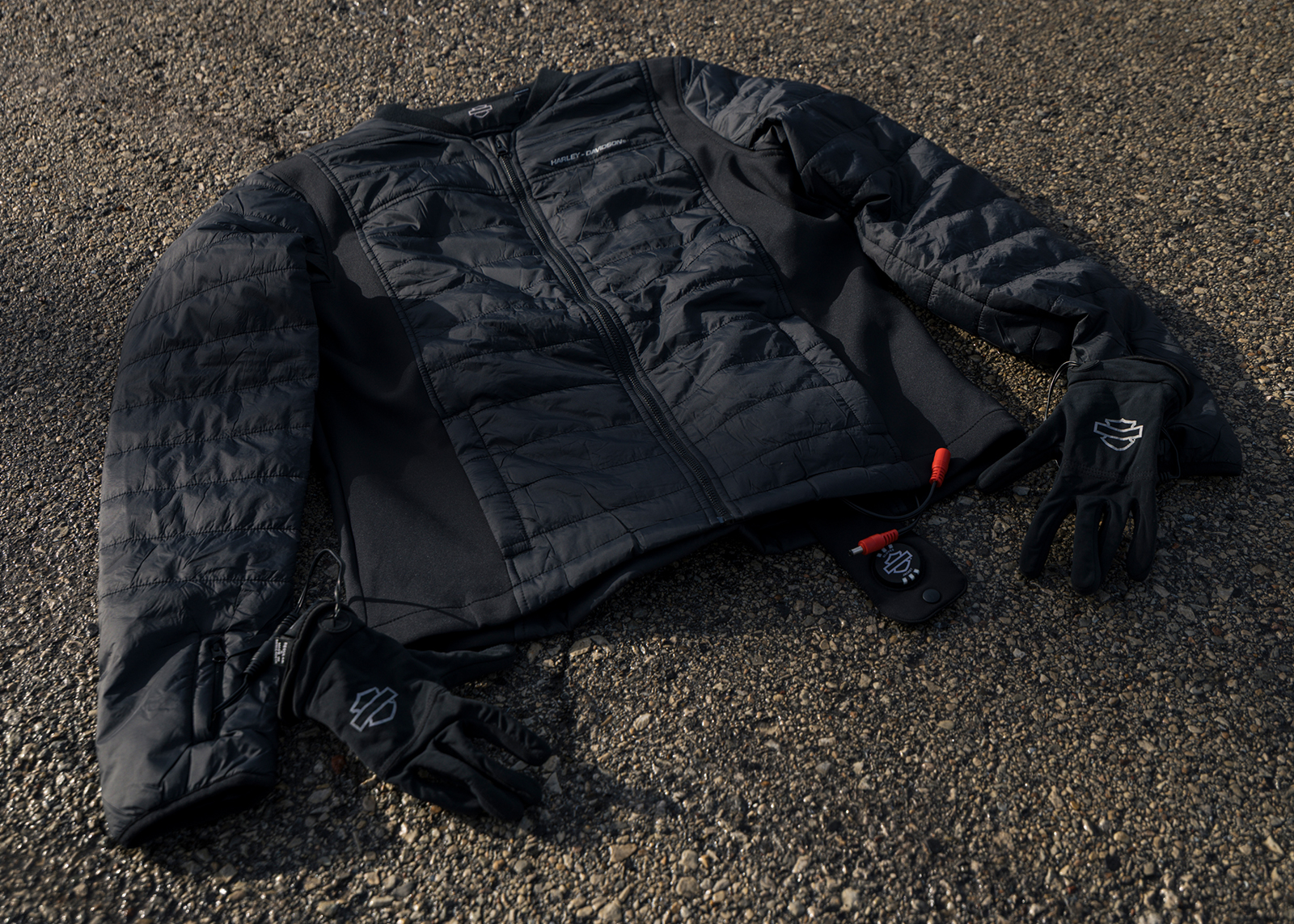  A lay down shot of the Harley-Davidson heated jacket and gloves, showing connecting wires and heat controls