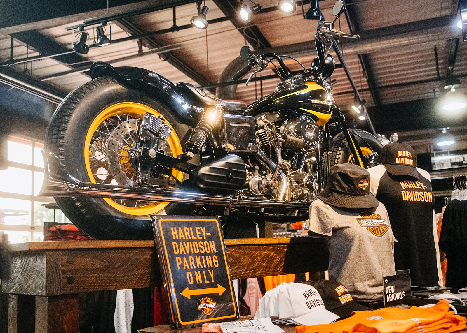 Black and yellow custom Harley in the middle of showroom floor.