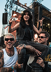 Woman on two man shoulders