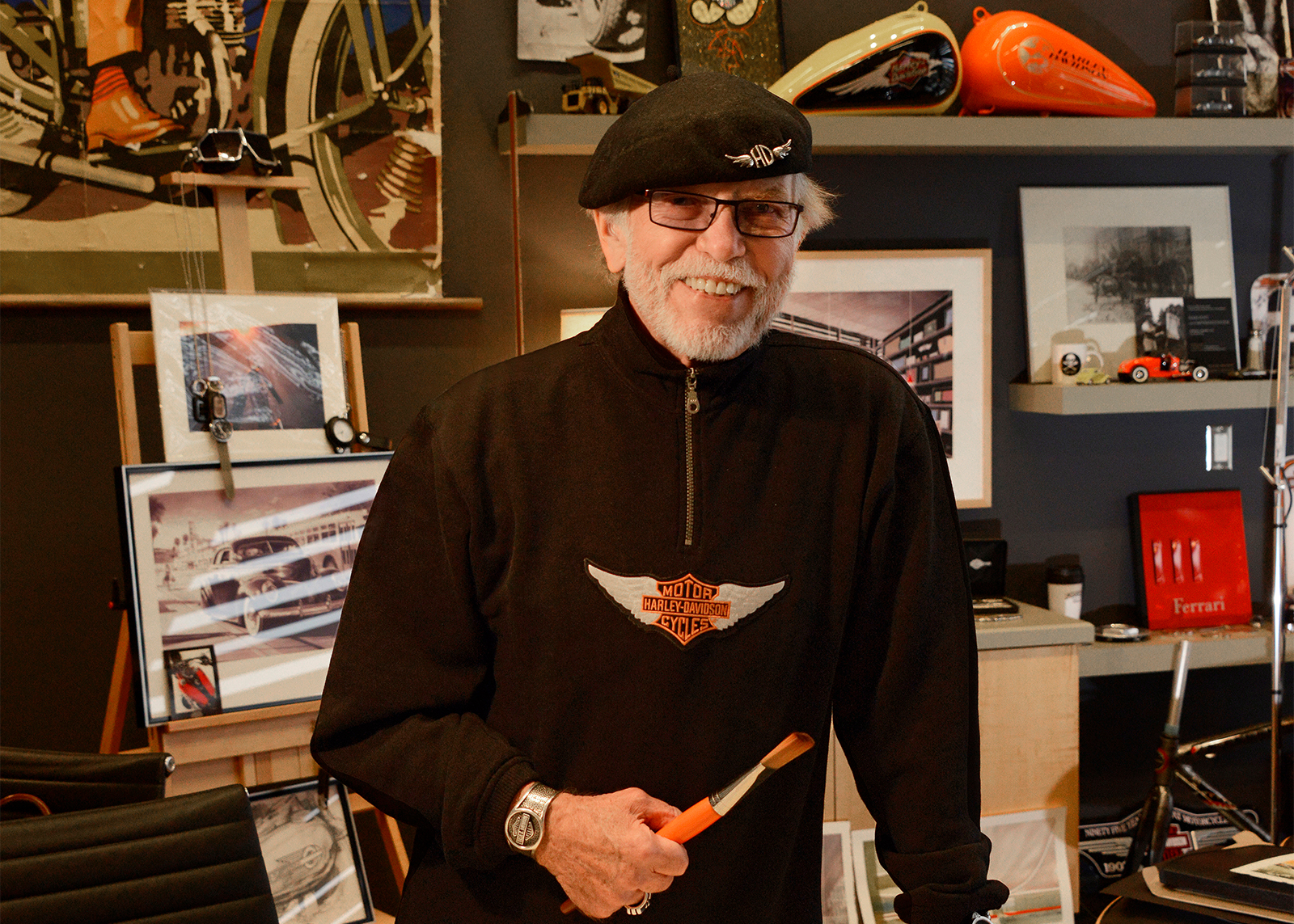 Willie G poses with a paintbrush