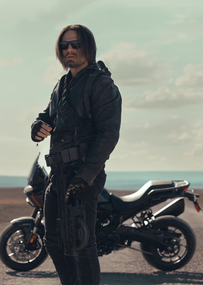 Actor Sebastian Stan stands near a Pan America 1250 ST