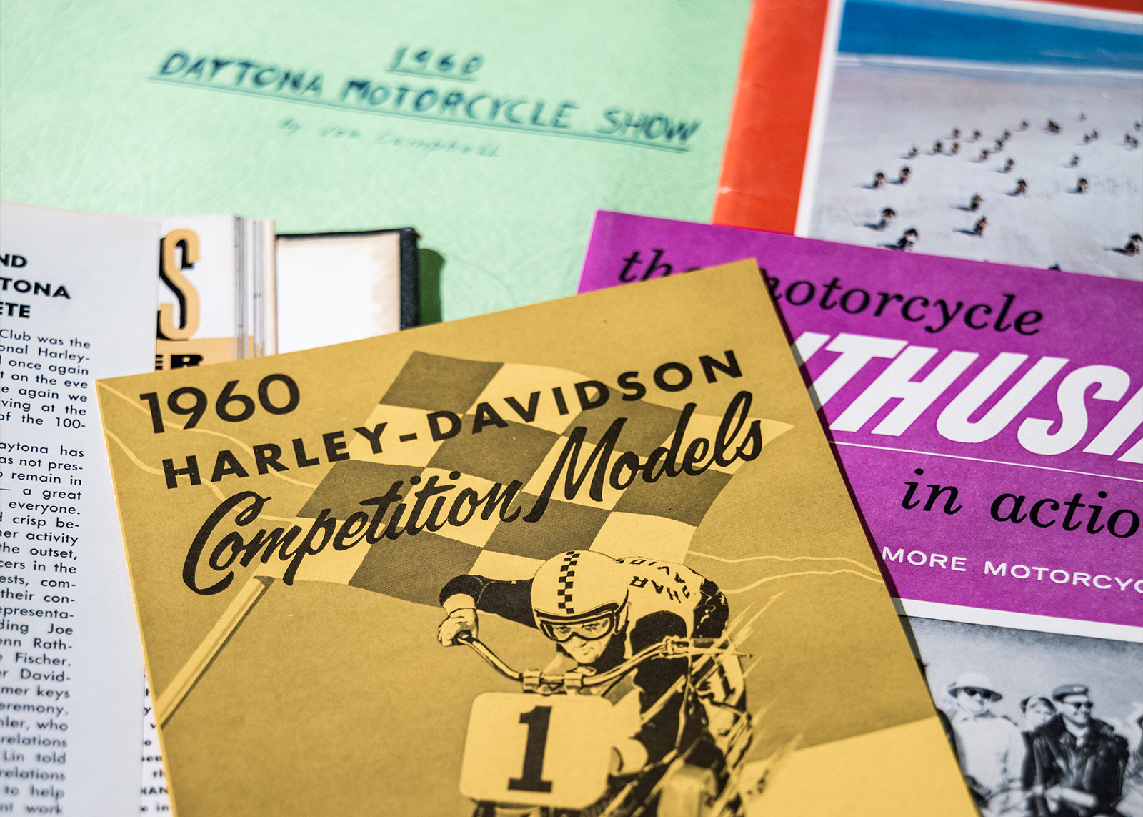 Vintage motorcycle magazines and documents including a 1960 Daytona Motorcycle Show booklet