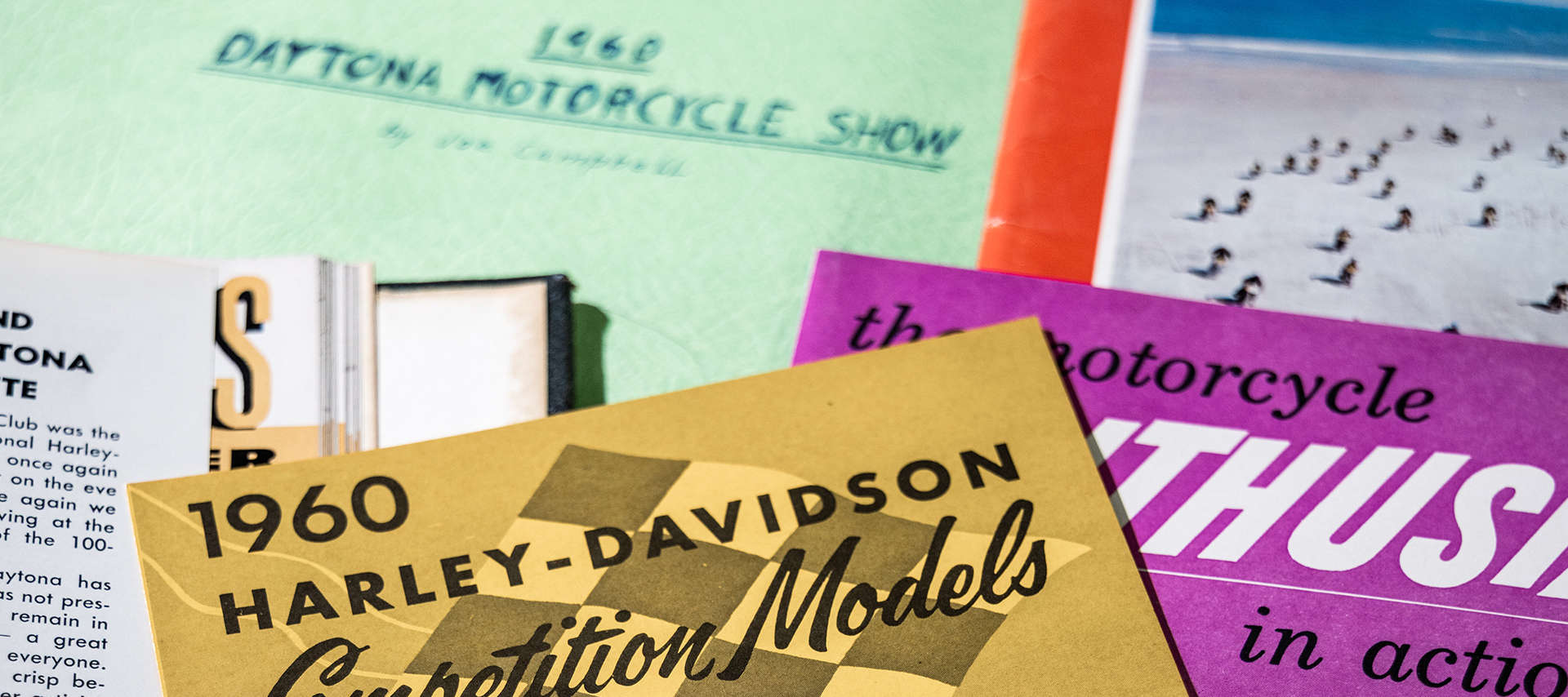 Vintage motorcycle magazines and documents including a 1960 Daytona Motorcycle Show booklet