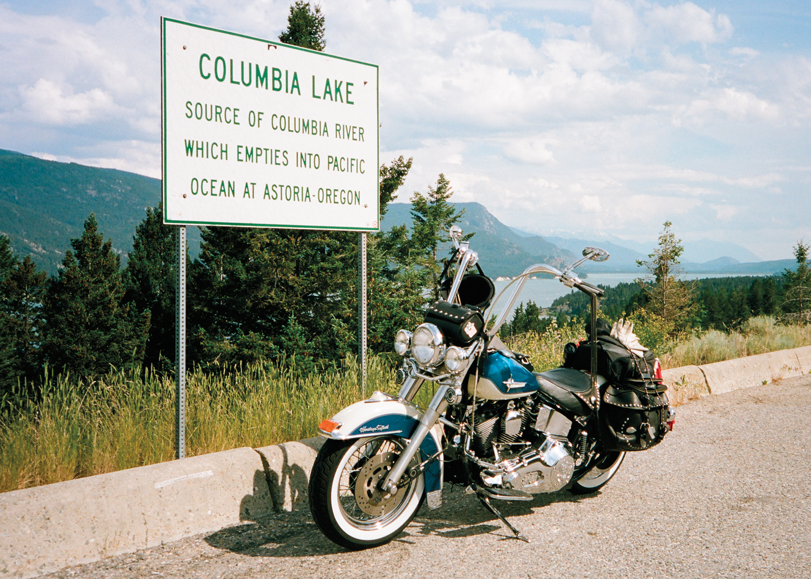 Blue and white Harley by Columbia Lake sign