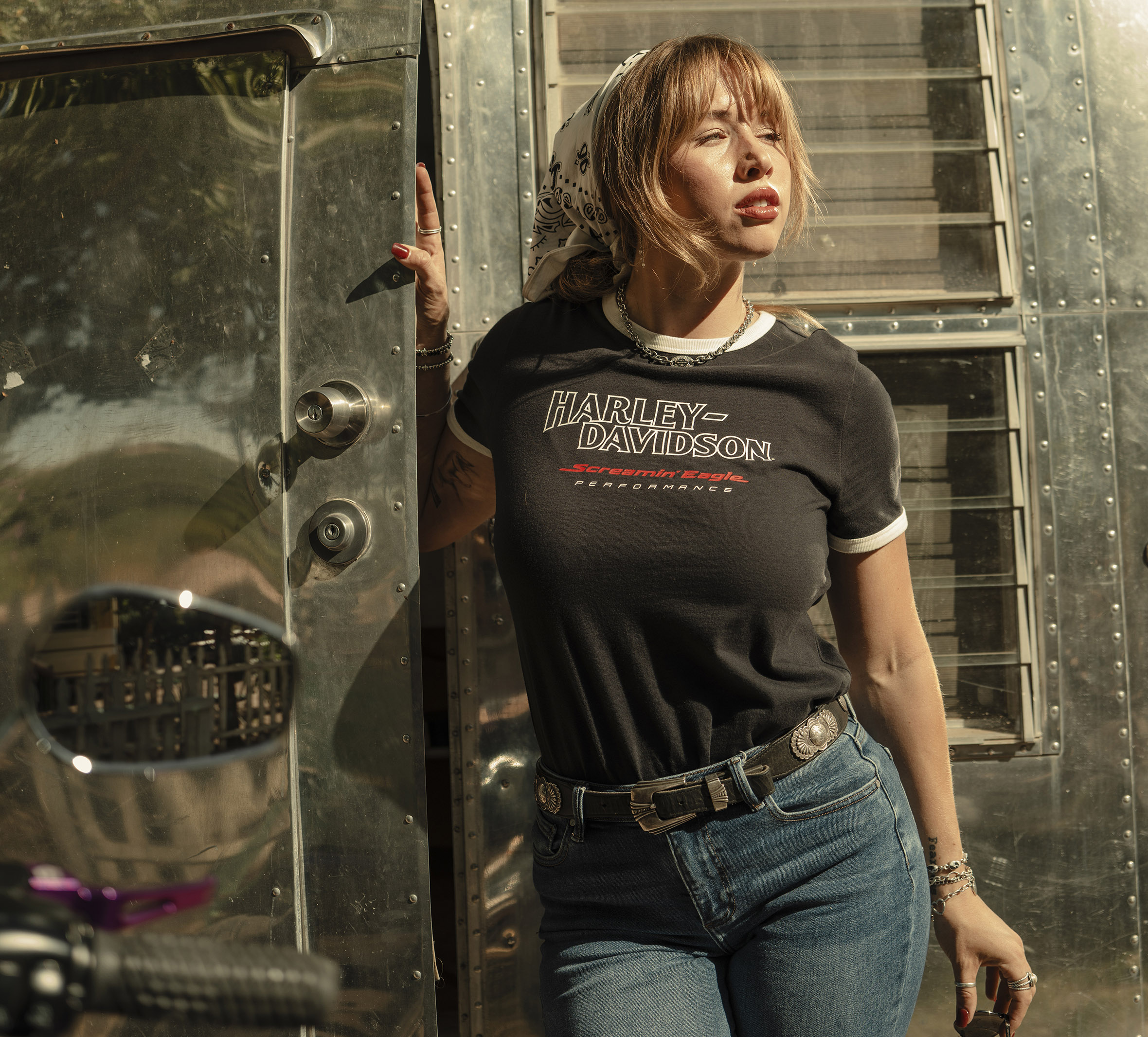 woman wearing tshirt standing by camper