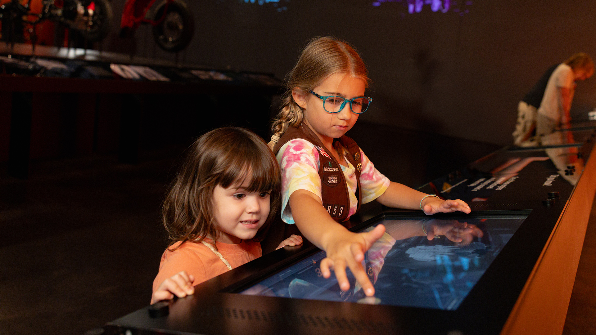 Two children interacting with touch screen display in museum exhibit