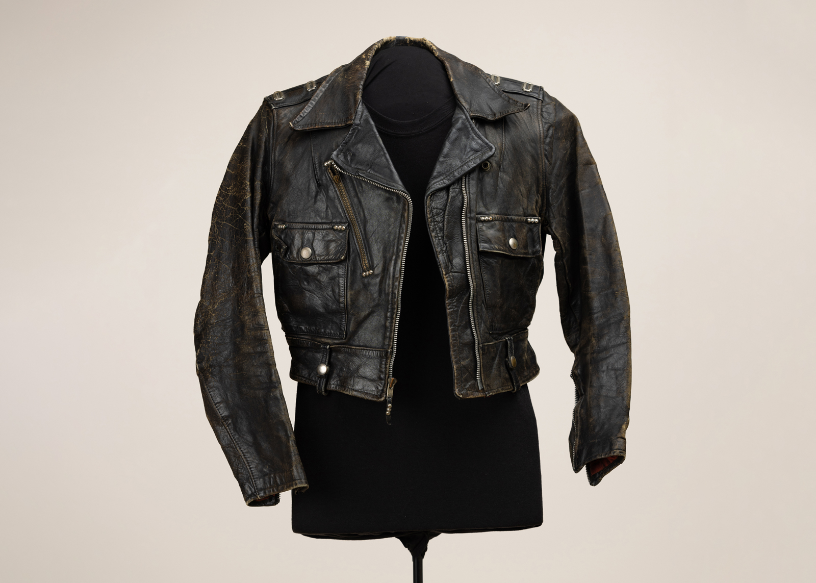 A vintage leather jacket on a mannequin