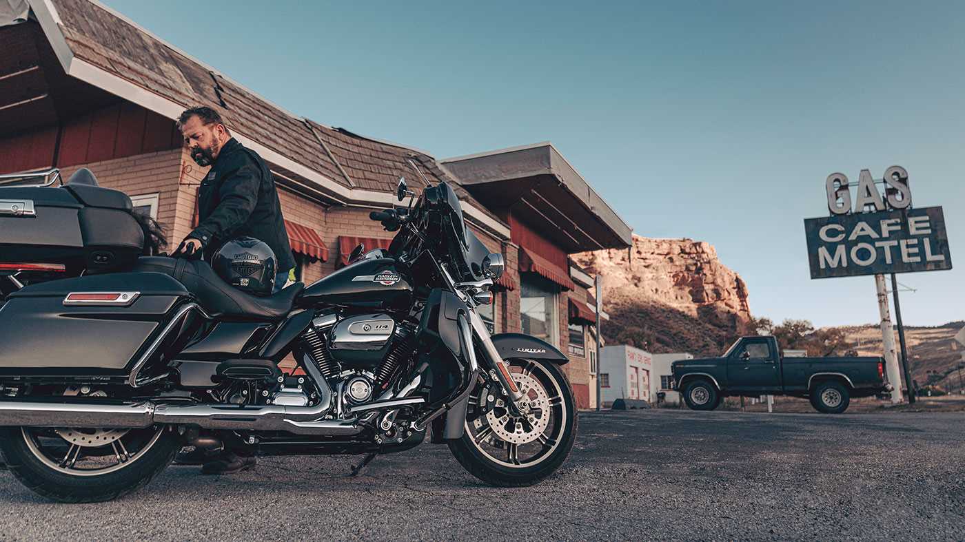 man next to parked motorcycle