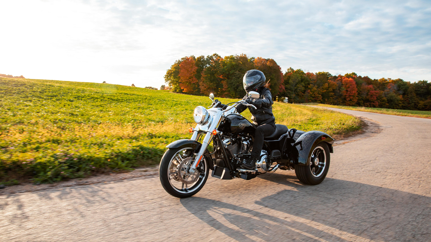 People learning to ride a motorcycle on a training range