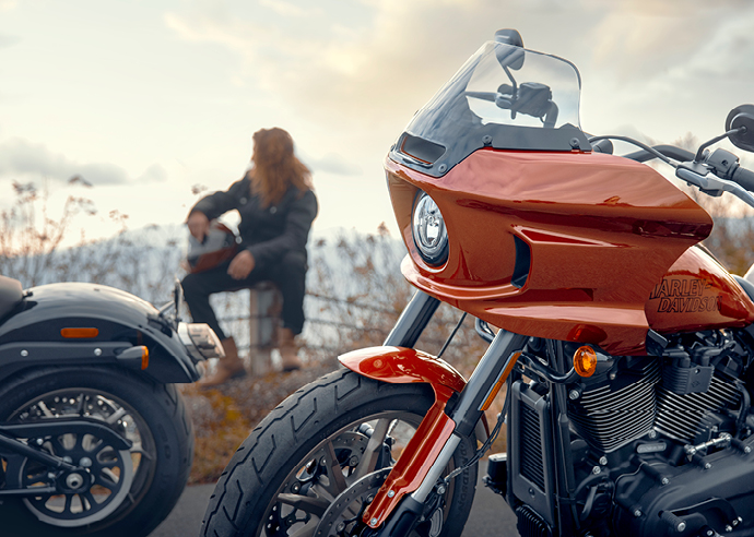 Mike Clark sits on fence on the side of the road 