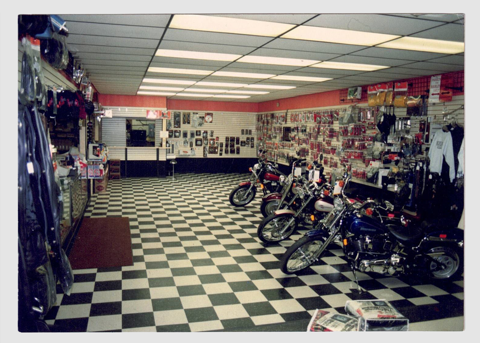 Vintage Bergen Harley-Davidson showroom interior with checkered floor and motorcycles on display.