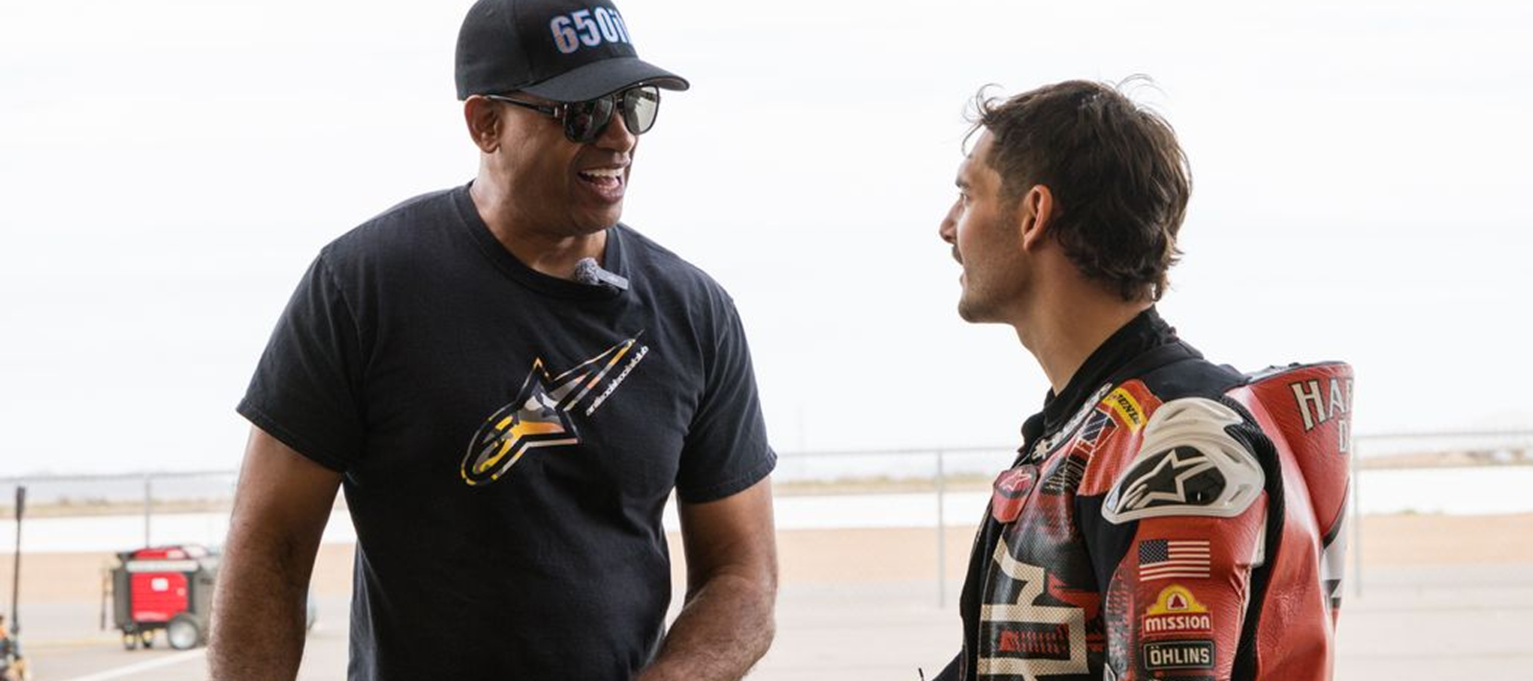 The author interviews racer James Rispoli who’s dressed in racing leathers after practice runs on the track