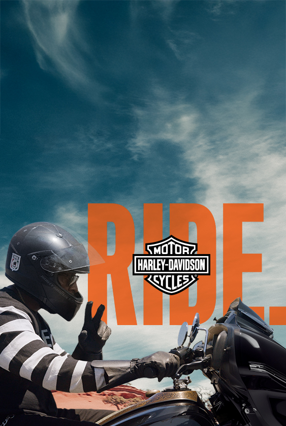 Eine Person, die eine schwarze Road Glide fährt und das Friedenszeichen zeigt