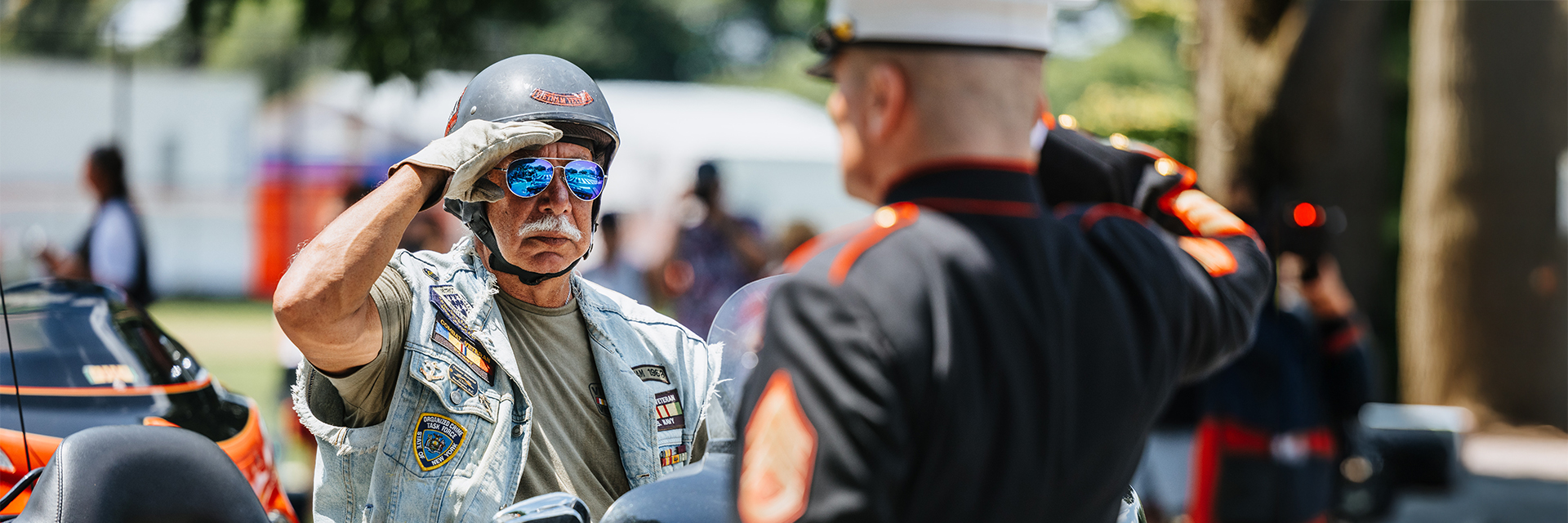 Harley Davidson rider salutes a US service member 