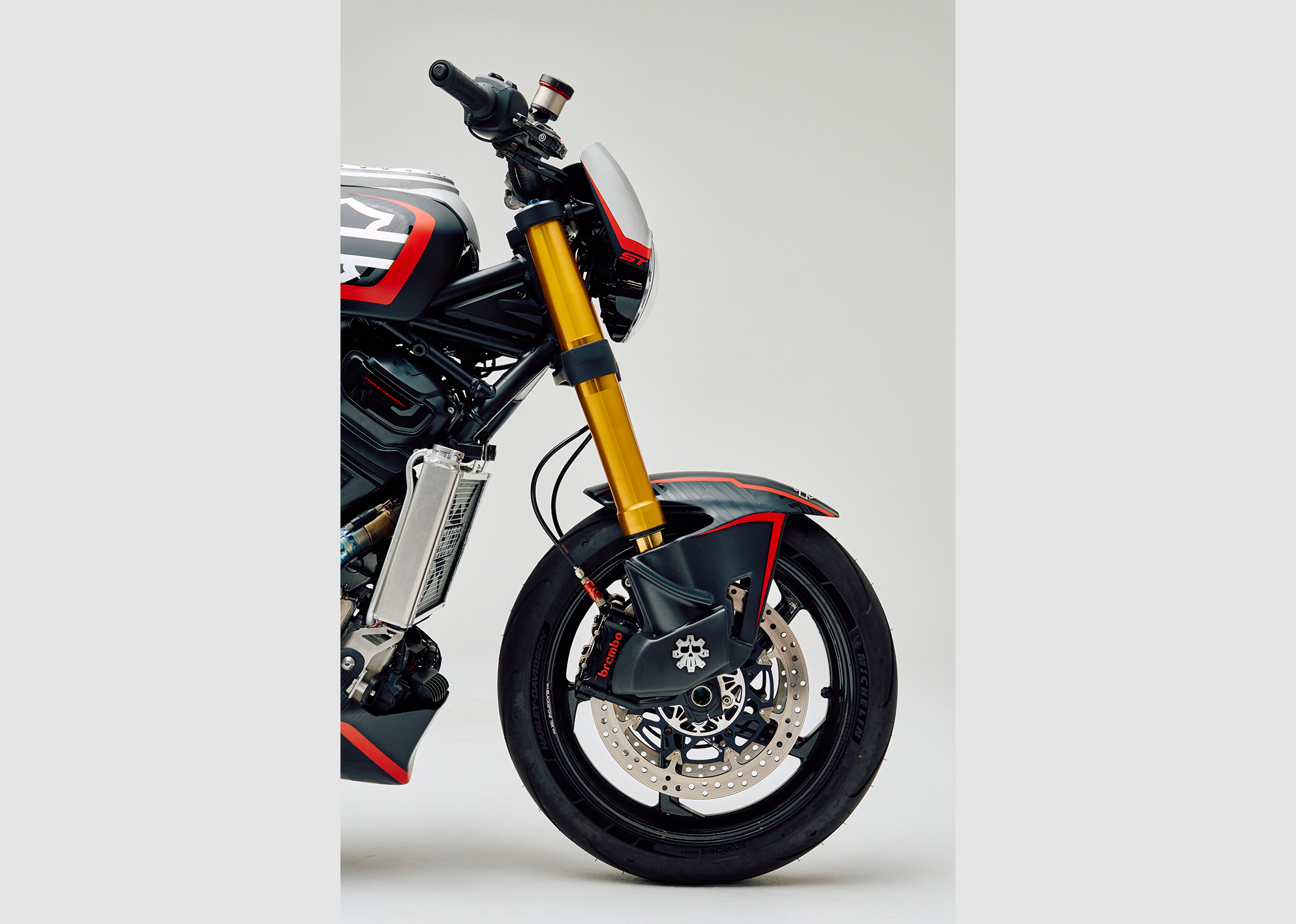 Close-up of the custom Pan America ST’s Öhlins x Screamin’ Eagle front end with gold forks, Brembo brakes, and BST Star TEK 17-inch front wheel.