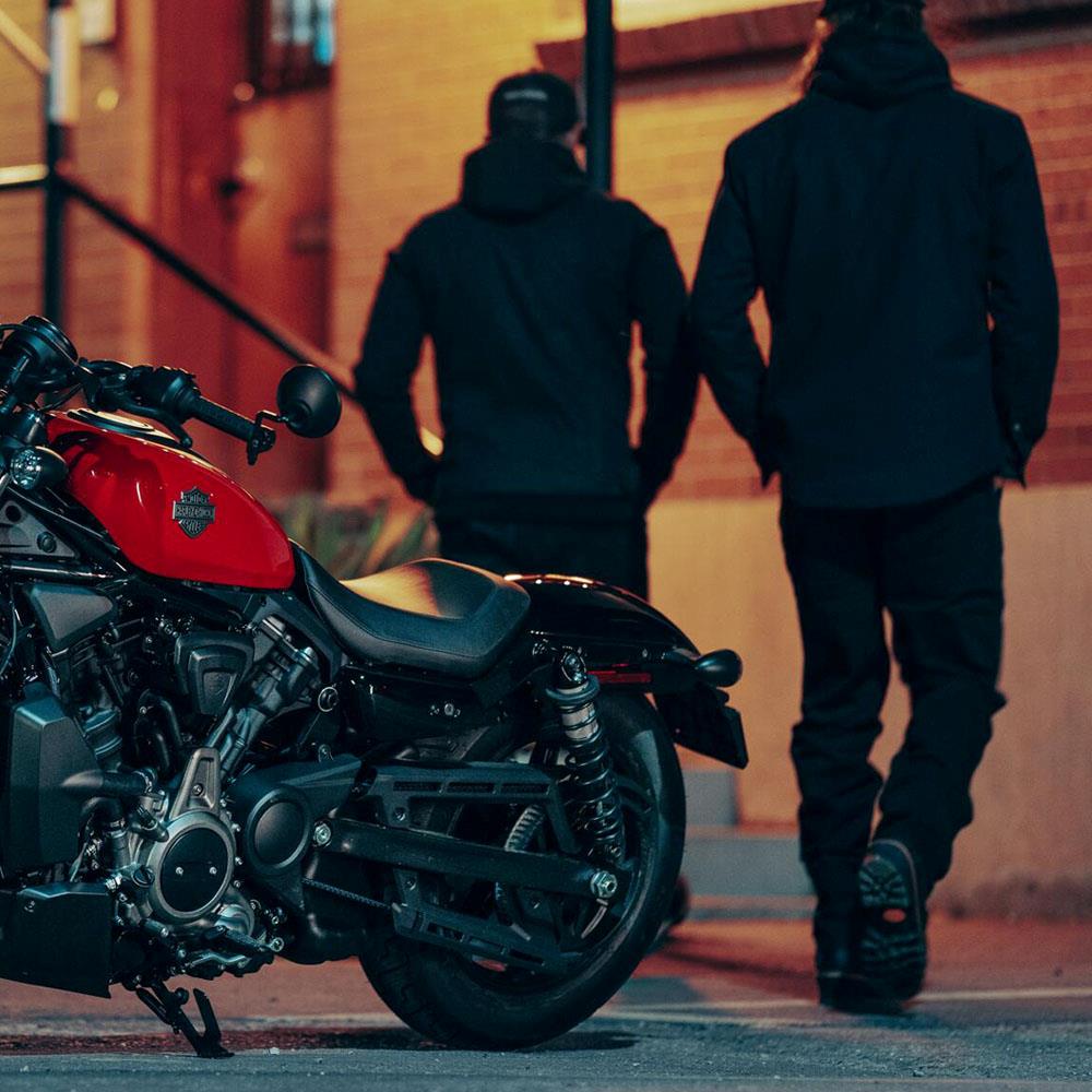 parked motorcycle and people walking into building