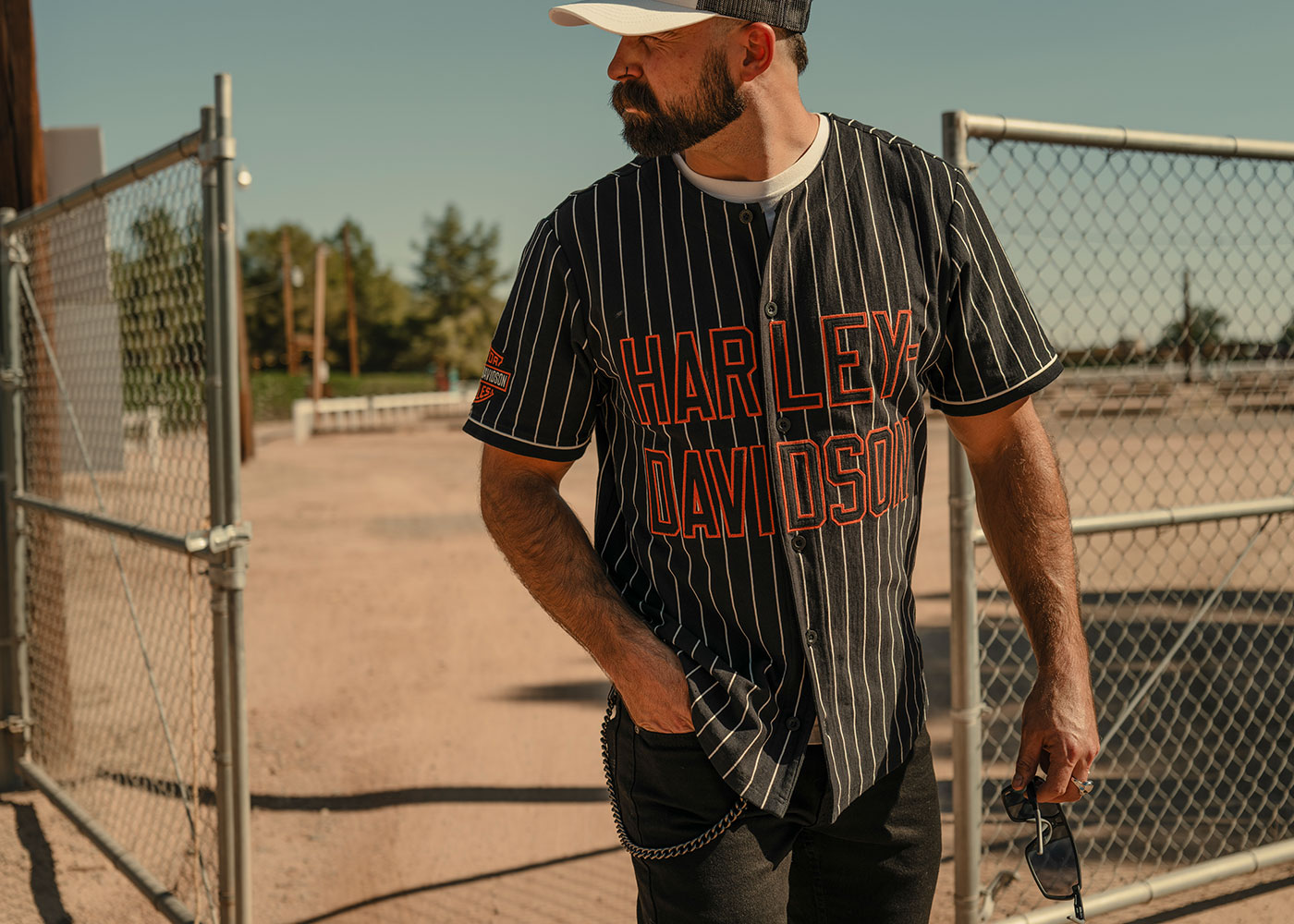 Man in a black Harley-Davidson baseball jersey shirt with white pinstripes