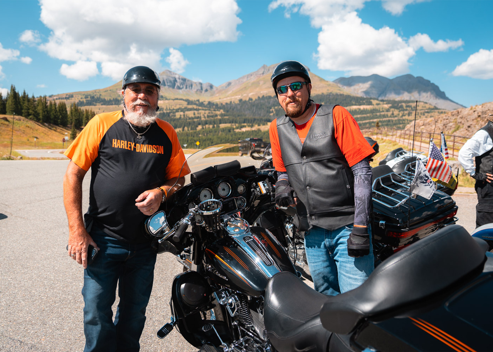 Two people stand on either side of a bike and smile 
