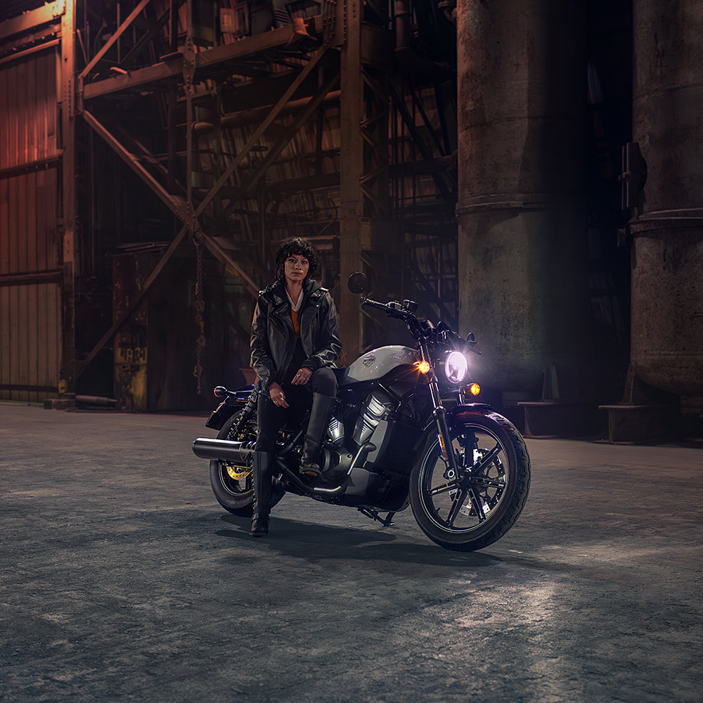 women sitting on motorcycle